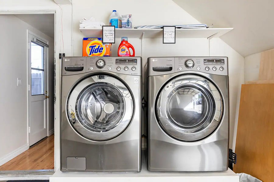 Washer and dryer accessible through the kitchen located in the garage