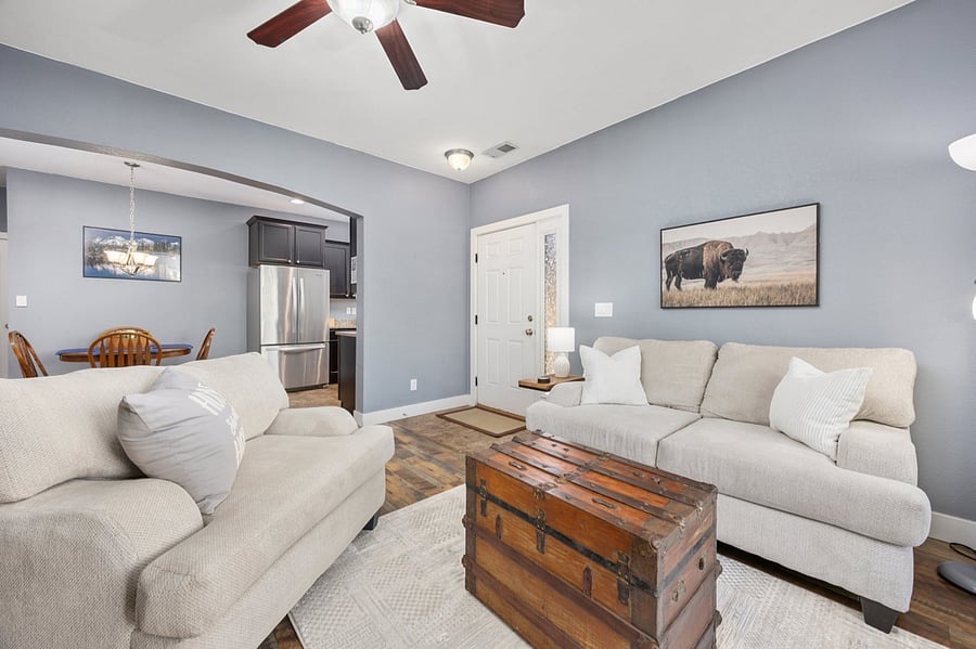 Living room with loveseat and oversize chair, gas fireplace and 50" Smart TV