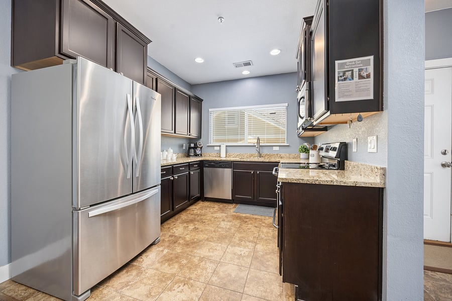 Updated kitchen with granite countertops, stainless steel appliances, and fully equipped