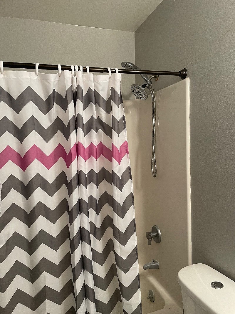 Bathroom with show curtain provided and updated shower head