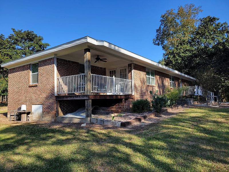 private covered deck overlooking grove of trees