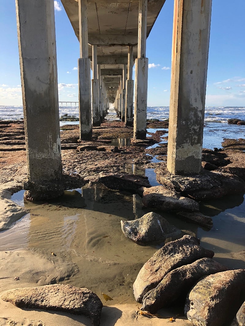 View of the Ocean Beach Pier from the beach at low tide.