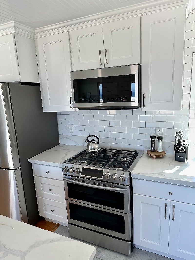 Over the range microwave and stainless steel gas stove/oven.