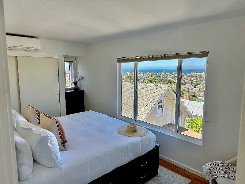 Primary bedroom with King storage bed and stunning views of the ocean.