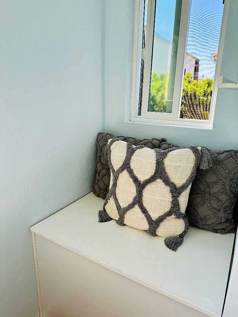 Window seat with lift top access to storage.