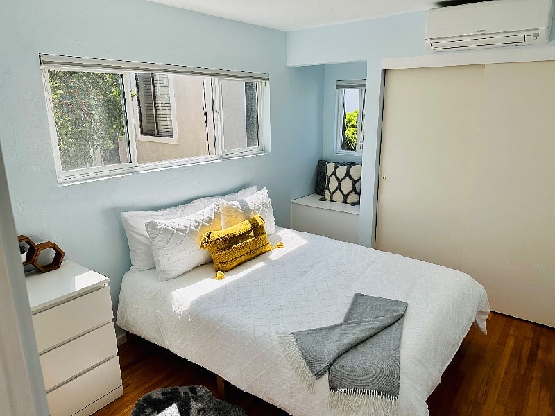Secondary bedroom with queen size bed, window seat with lift top access to storage.