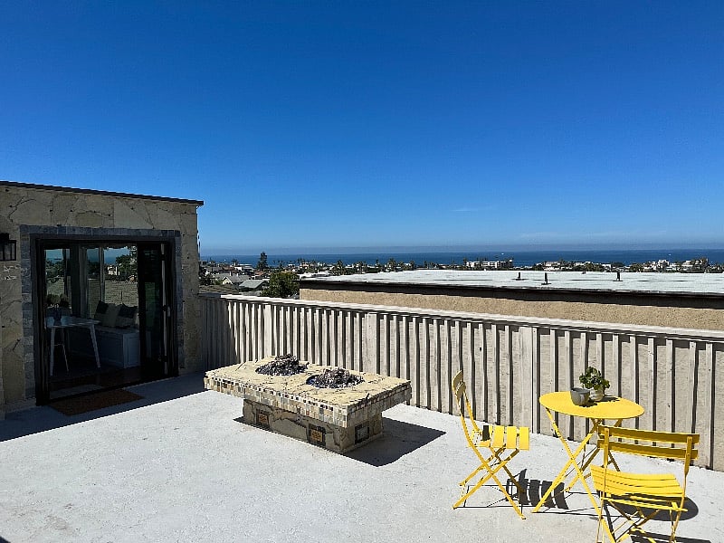 Large deck overlooking the ocean with two fire pits and bistro set.