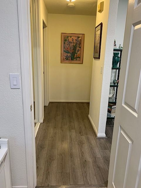 View of hallway from bedroom to living room and bathroom