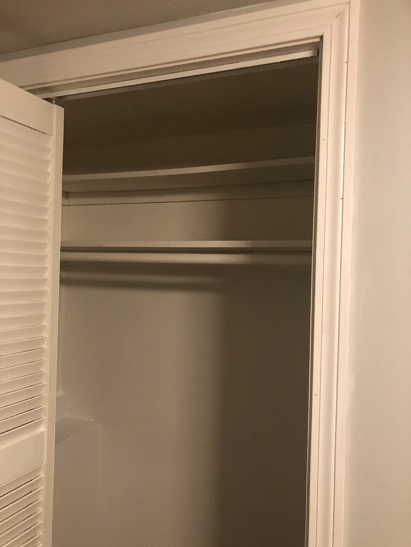 Full size closet with folding door,  2 top shelves, hangers, ironing board, iron, and plenty of space for storage 