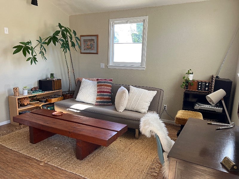 Living room area couch folds down into another double bed. 