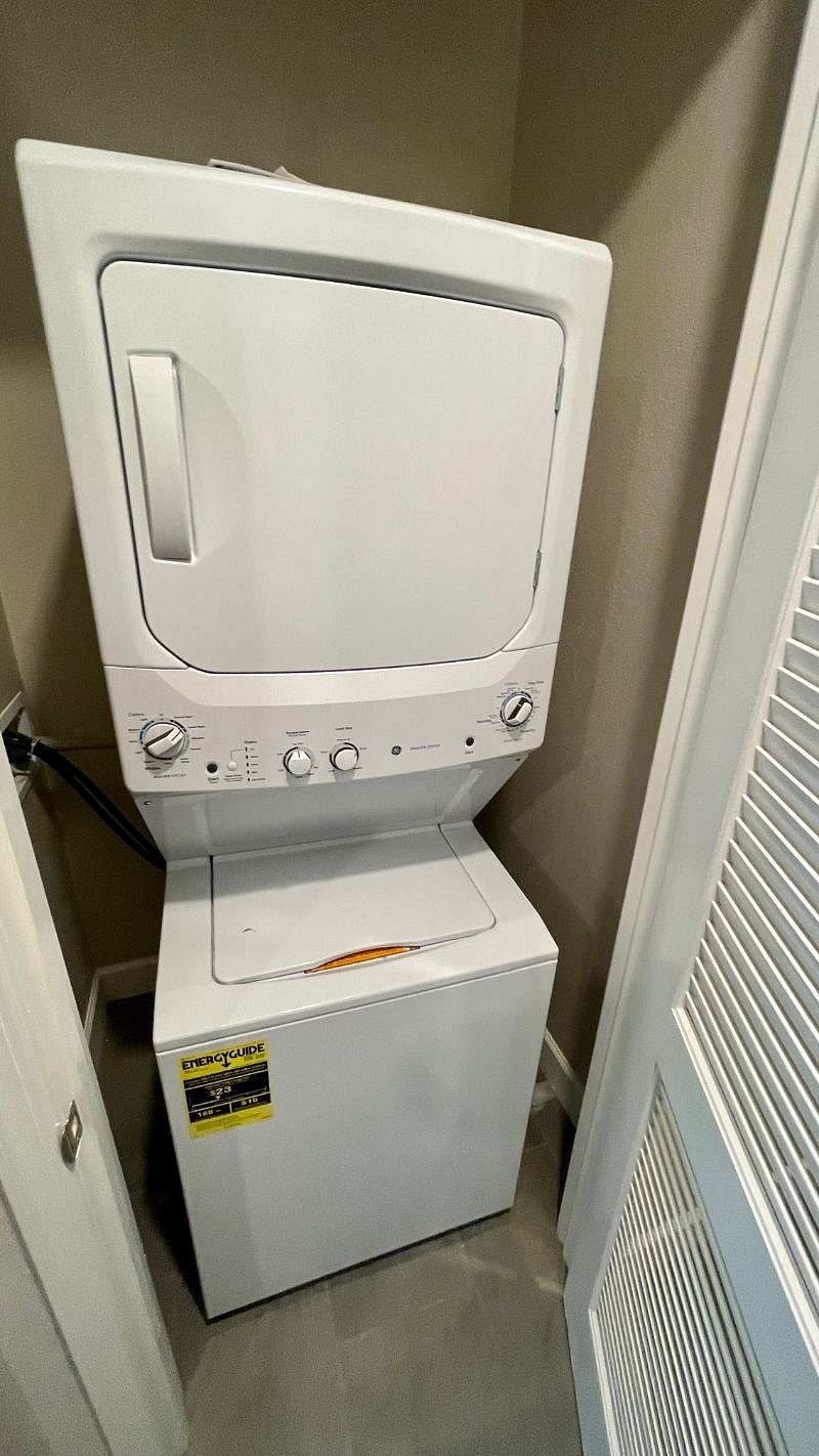 Stacked full size washer and dryer.