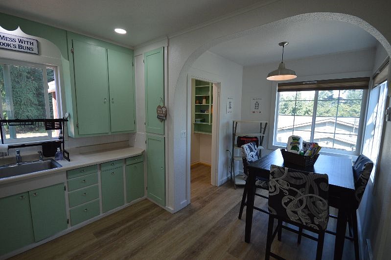 Kitchen is fully stocked with dishes, glasses and mugs, utensils, toaster, coffee maker and cookware.
