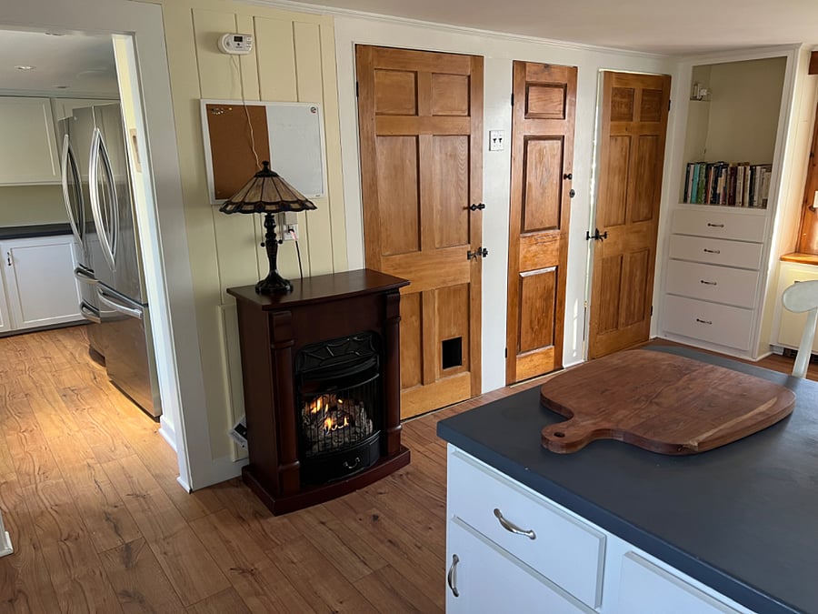 In the winter, the kitchen fireplace is toasty warm. Two large refrigerators are in the pantry.