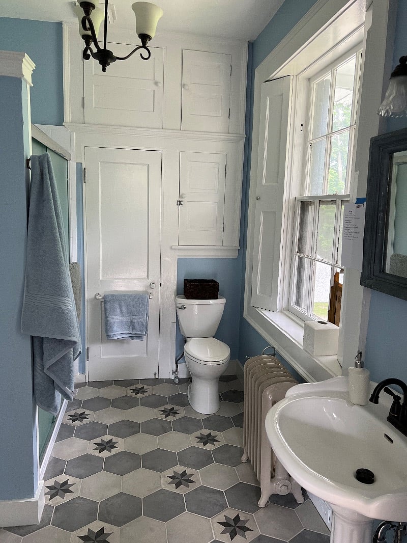 The bathroom is equipped with an entirely new shower/bath and new tile floor.