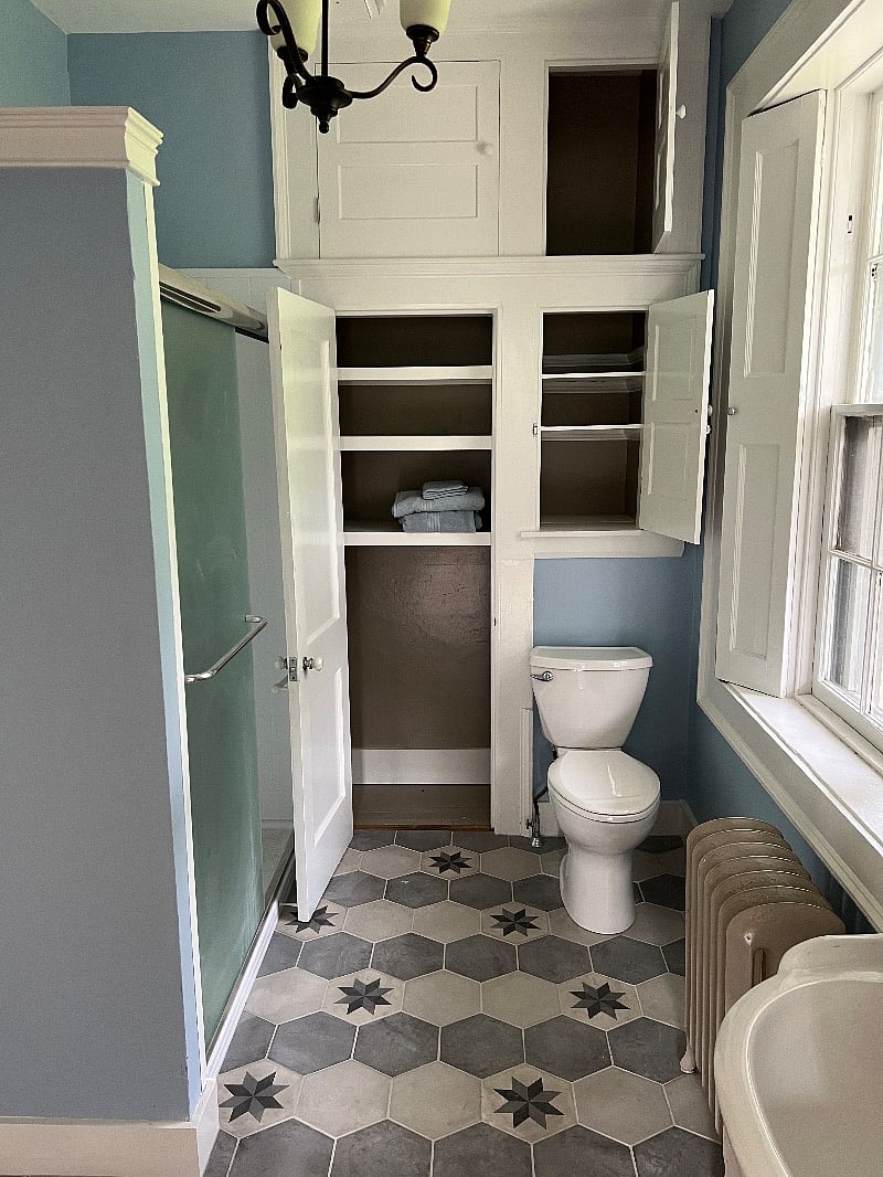 The bathroom has an entire wall of closets for storage.