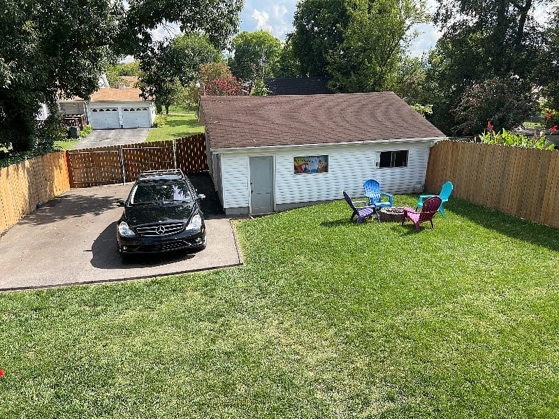Fenced in backyard with parking for four cars.
Garage not available