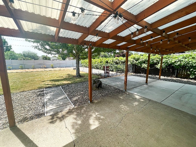 Covered area to enjoy the beautiful backyard rain or shine with string lights.