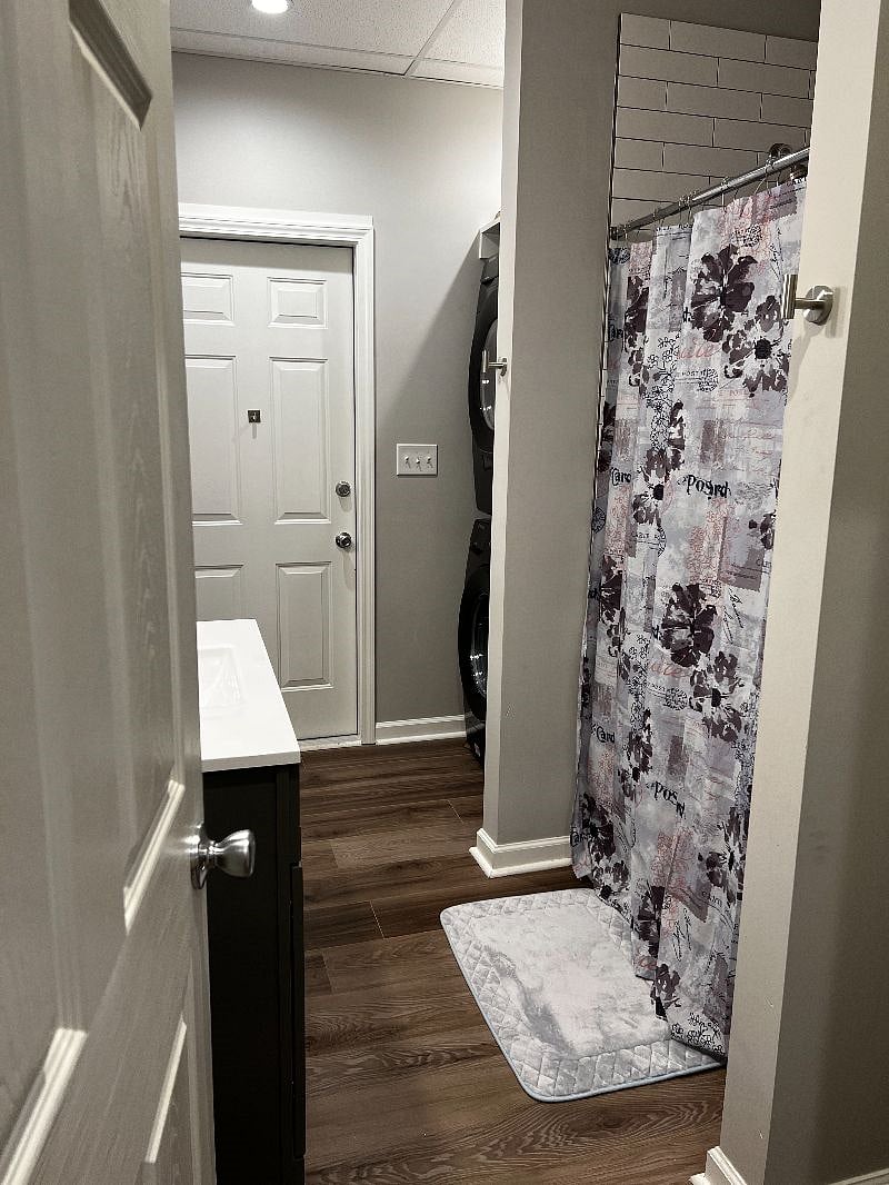 Full bathroom with walk-in shower, washer and dryer and private toilet room.