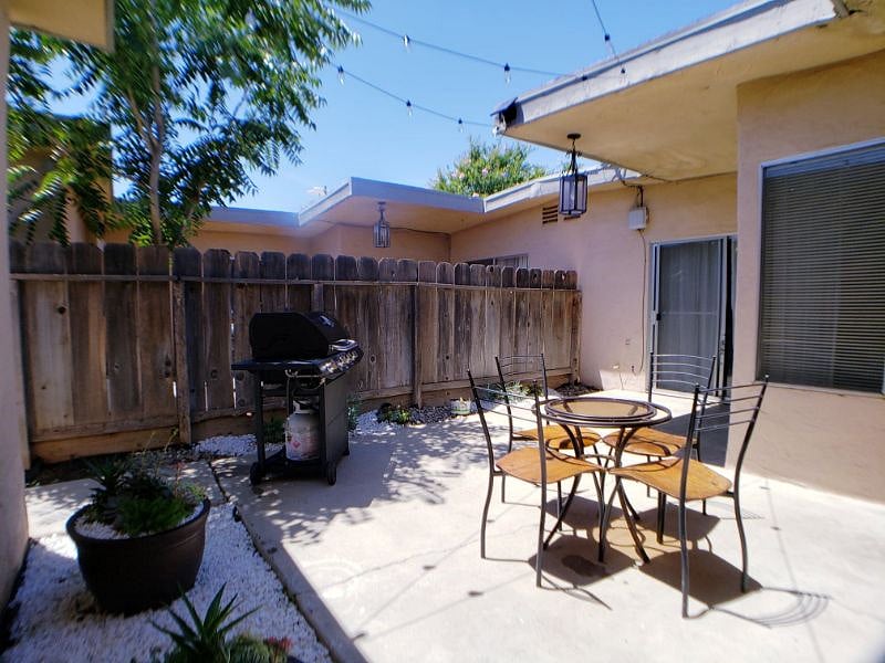 Rear Patio area with Barbeque area and surrounded by succelent plants.