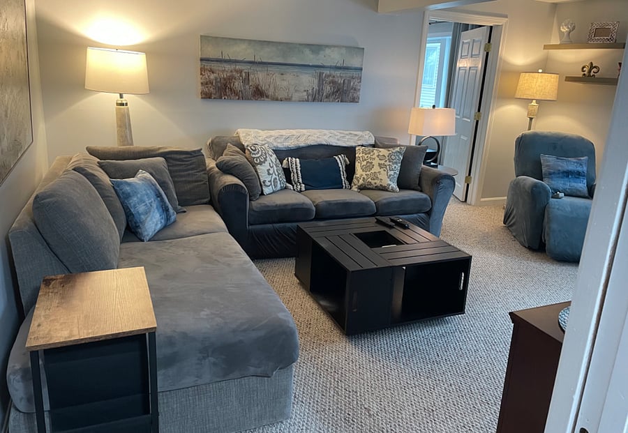 Living room couches and recliner. Entry to bedroom.