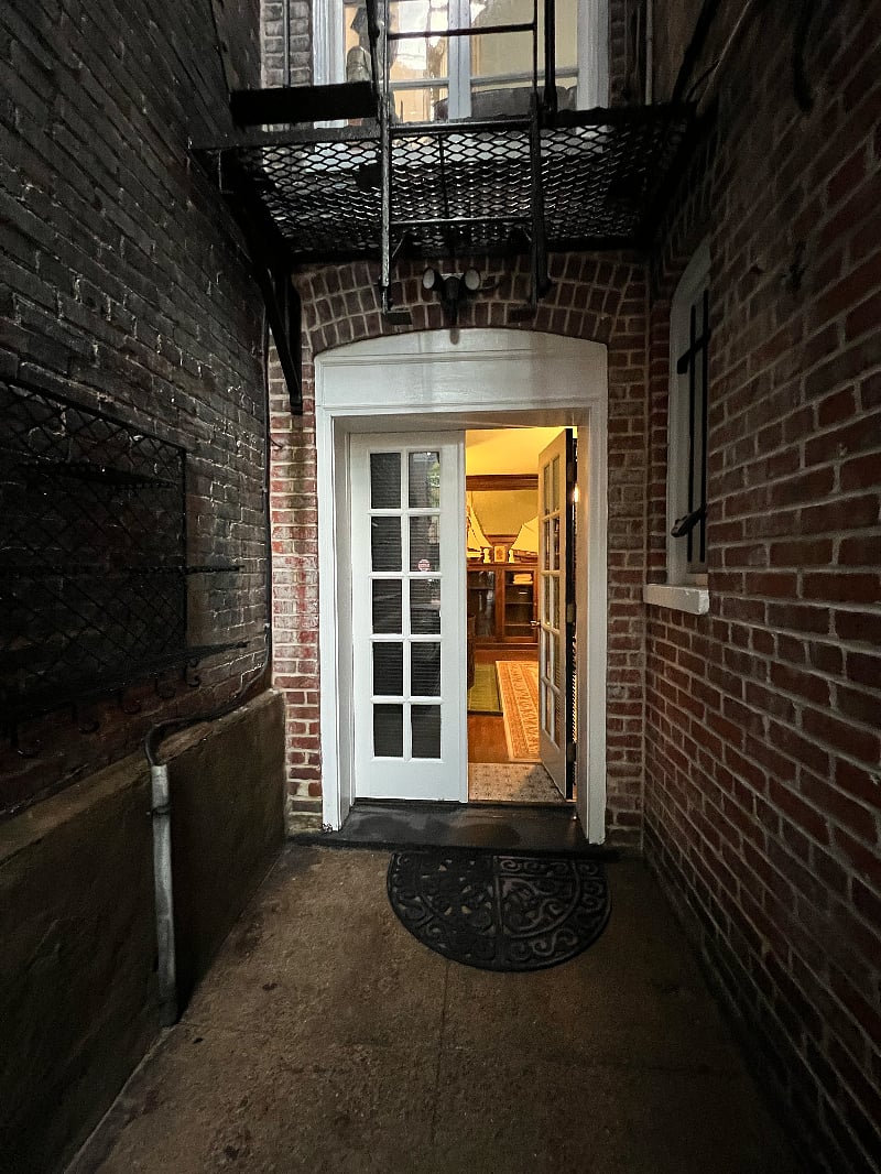 If you're staying in the walnut paneled room, you also have a separate entrance which is at the back of the row house.