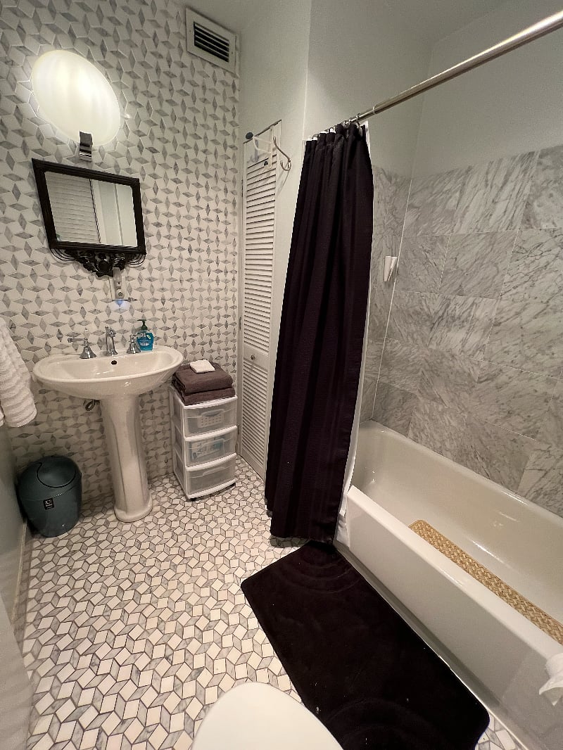 Gorgeous marble master bathroom in the walnut paneled room