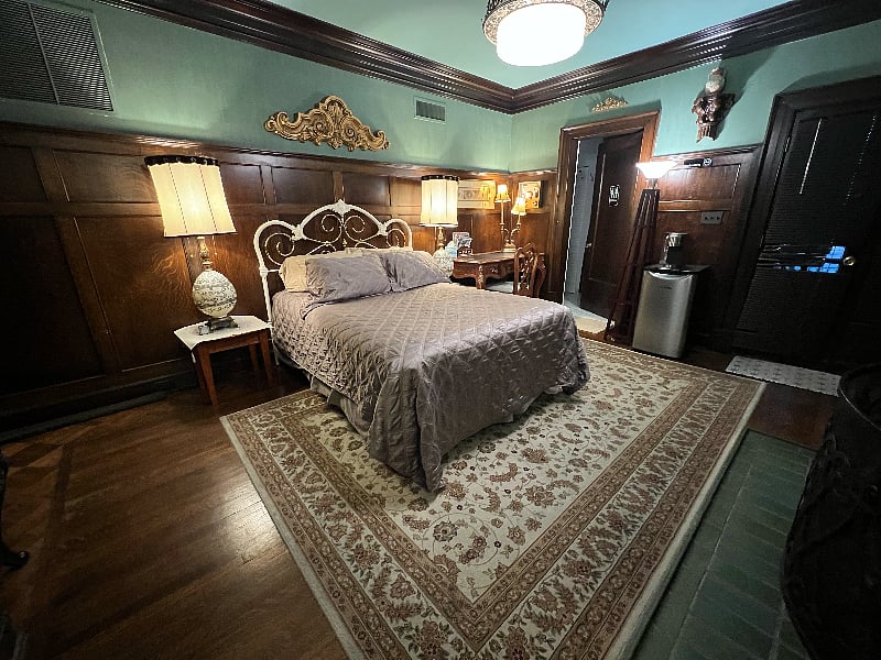 Bedroom with walnut panels in historic home.