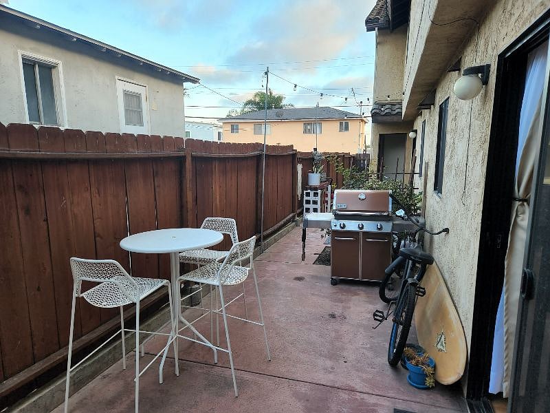 Back patio with BBQ and outdoor table with chairs