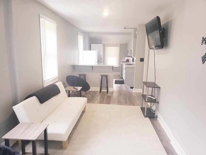 Living Room with Futon, Custom Built Breakfast Bar w/ stools and various seating options