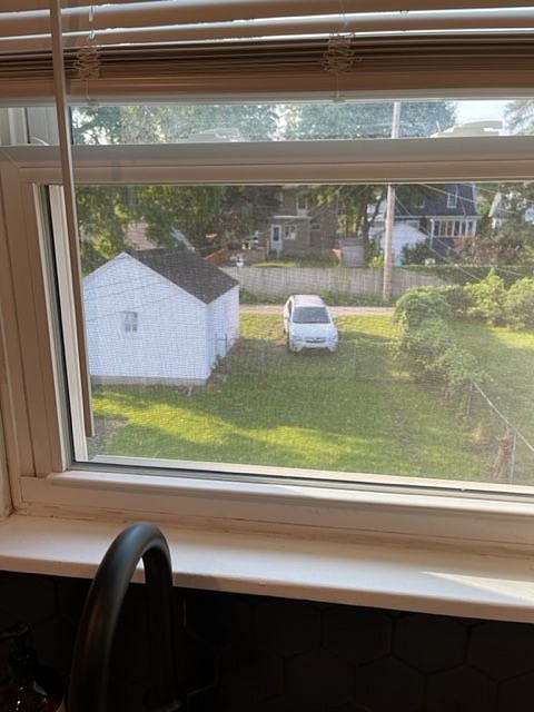 View to backyard, alley, garage and alley parking from window