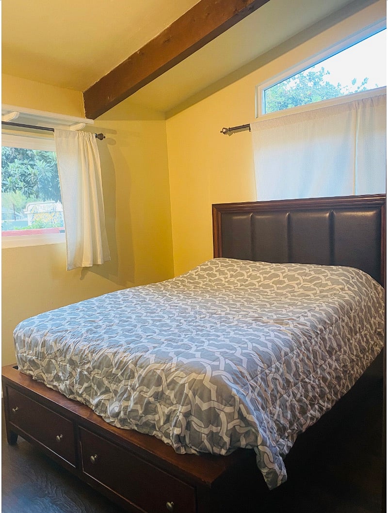 Guest bedroom with large spacious closet and outlots of natural lighting and scenery