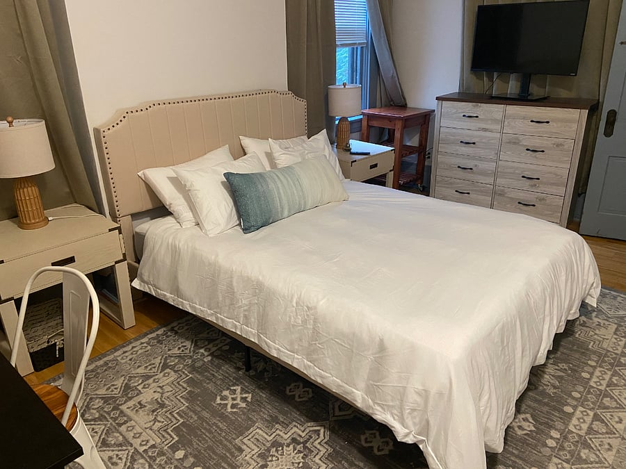 Main bedroom with storage dresser and large closet