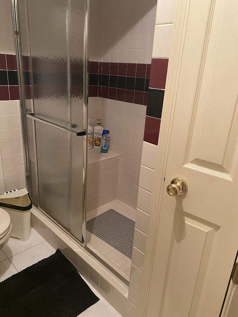 Private bathroom with spacious shower and closet space.
