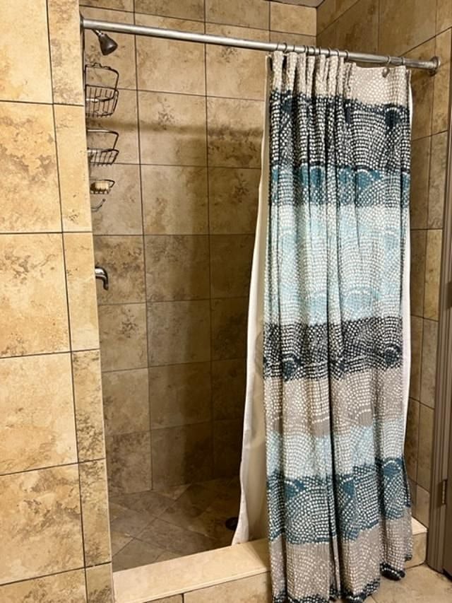 Master bedroom bathroom has tile to the ceiling and outside wall