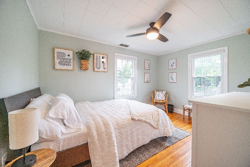 Green guest bedroom with queen size bed