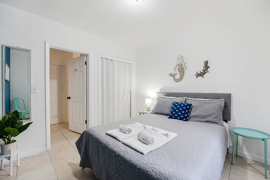 Spacious bedroom with a queen size bed designed for comfort and tranquility.