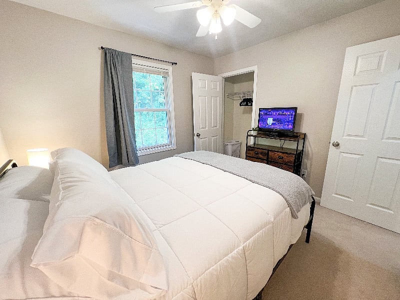 Bedroom 2 also has a ceiling fan, black out curtain, clothes closet with a laundry hamper, & dresser!