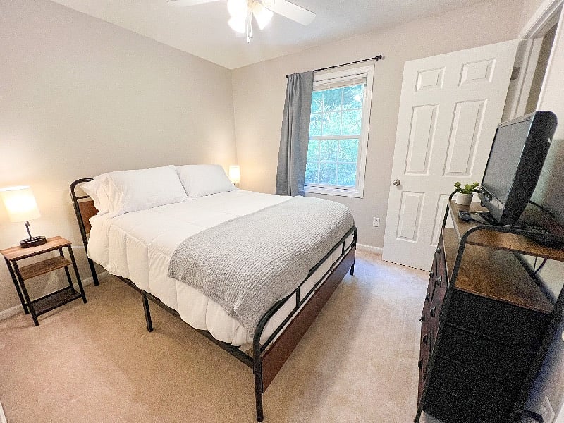 Bedroom 2 is so rustic & cozy! It has an extremely comfortable queen mattress topped with the softest sheets, comforter, & throw blanket!