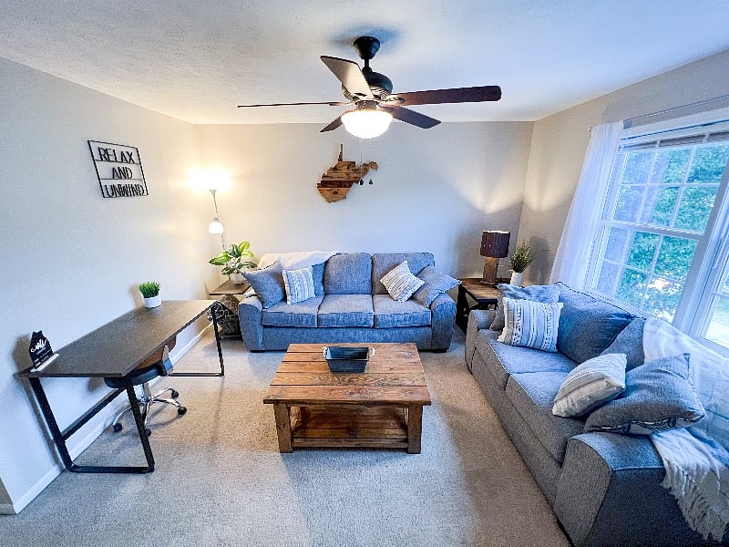 The living room has comfy couches & a 50" TV with ROKU for streaming. There is also a desk for your home office needs.