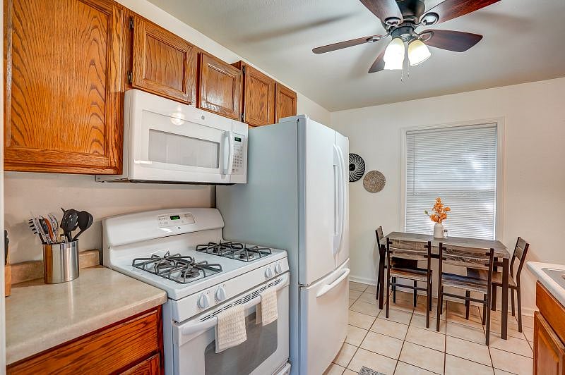 Kitchen includes dishwasher, French door refrigerator, and dining table.