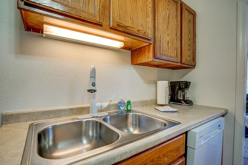 Kitchen with dishwasher. Fully stocked with all the dishes and cooking utensils you'll need to cook a meal.