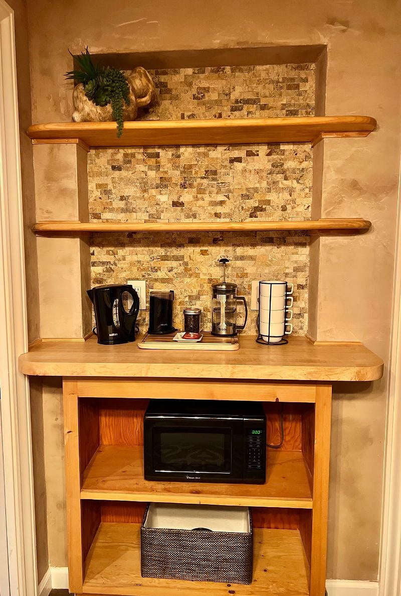 Fully equipped coffee bar with french press, grinder, pour-over cone and starter filters, coffee, cream and sugar