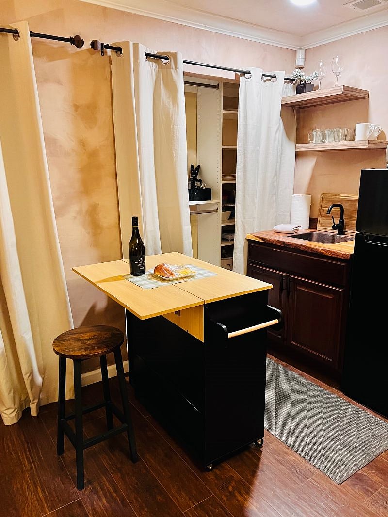 Kitchenette with a drop leaf rolling island and barstool for extra prep space, storage or to transform into your dining area