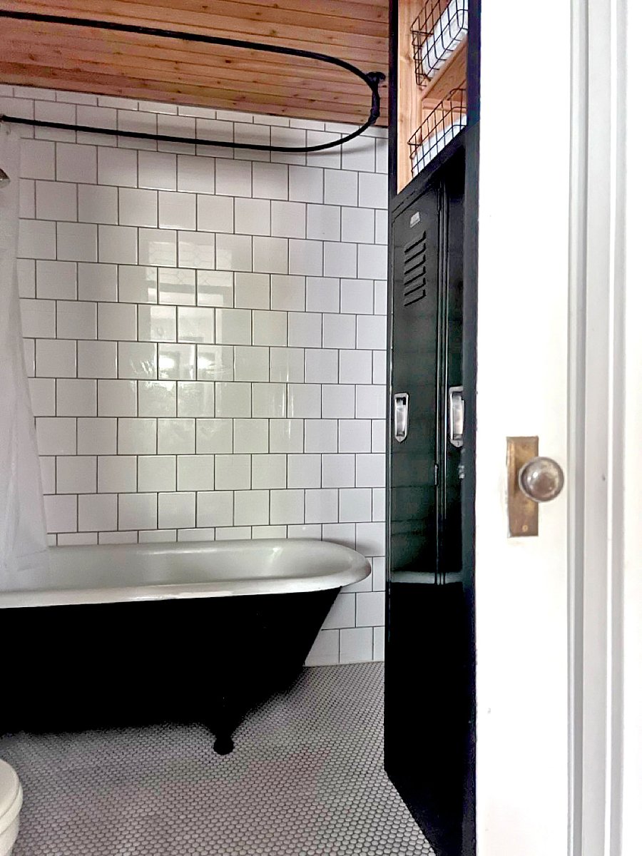 Bathroom - claw foot tub/shower, lockers for storage, toilet, sink, heated tile floor, pocket door