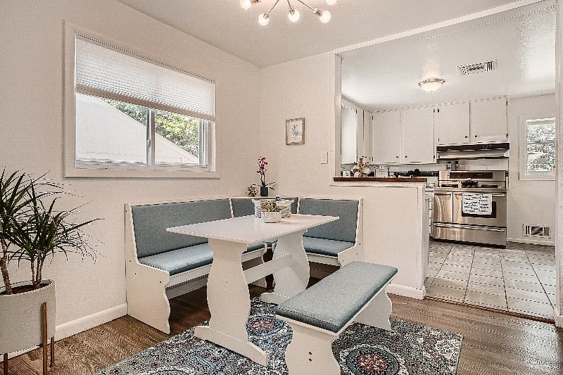 Living room and dining nook, with all new furnishings and fresh open-concept layout.