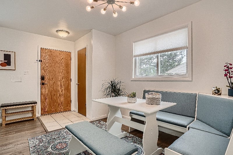 Living room and dining nook, with all new furnishings and fresh open-concept layout.