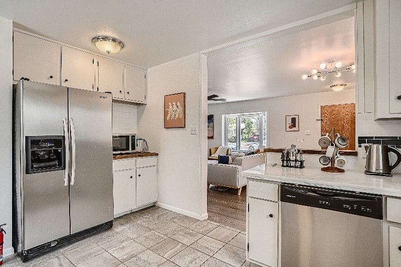 Full-sized refrigerator and stainless steel dishwasher (with complimentary pods). With a double oven, gas range, microwave, toaster, blender, water kettle, and 2 coffee makers, this beautiful kitchen is perfect for remote work, traveling nurses, families, and long-term stays.