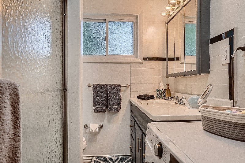 Full bathroom with convenient and eco-friendly washer/dryer unit, bath tub, and hot shower - and did we mention complimentary bath bombs?  We also provide a hair straightener, hair dryer, and extra tooth brushes in case you forget yours :)
