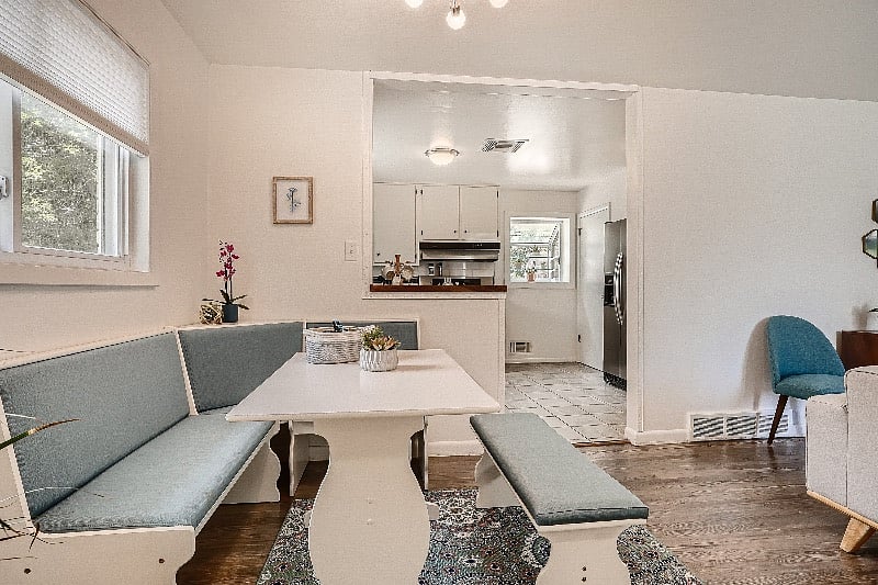 Living room and dining nook, with all new furnishings and fresh open-concept layout.