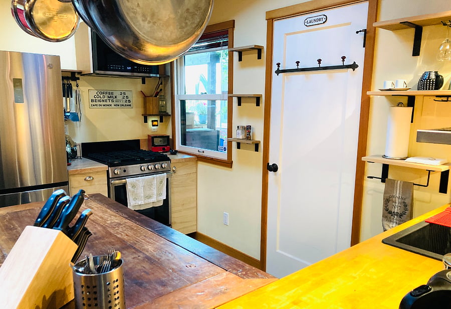 Full size fridge-freezer, gas range (4-burner stovetop & oven), large microwave, laundry closet